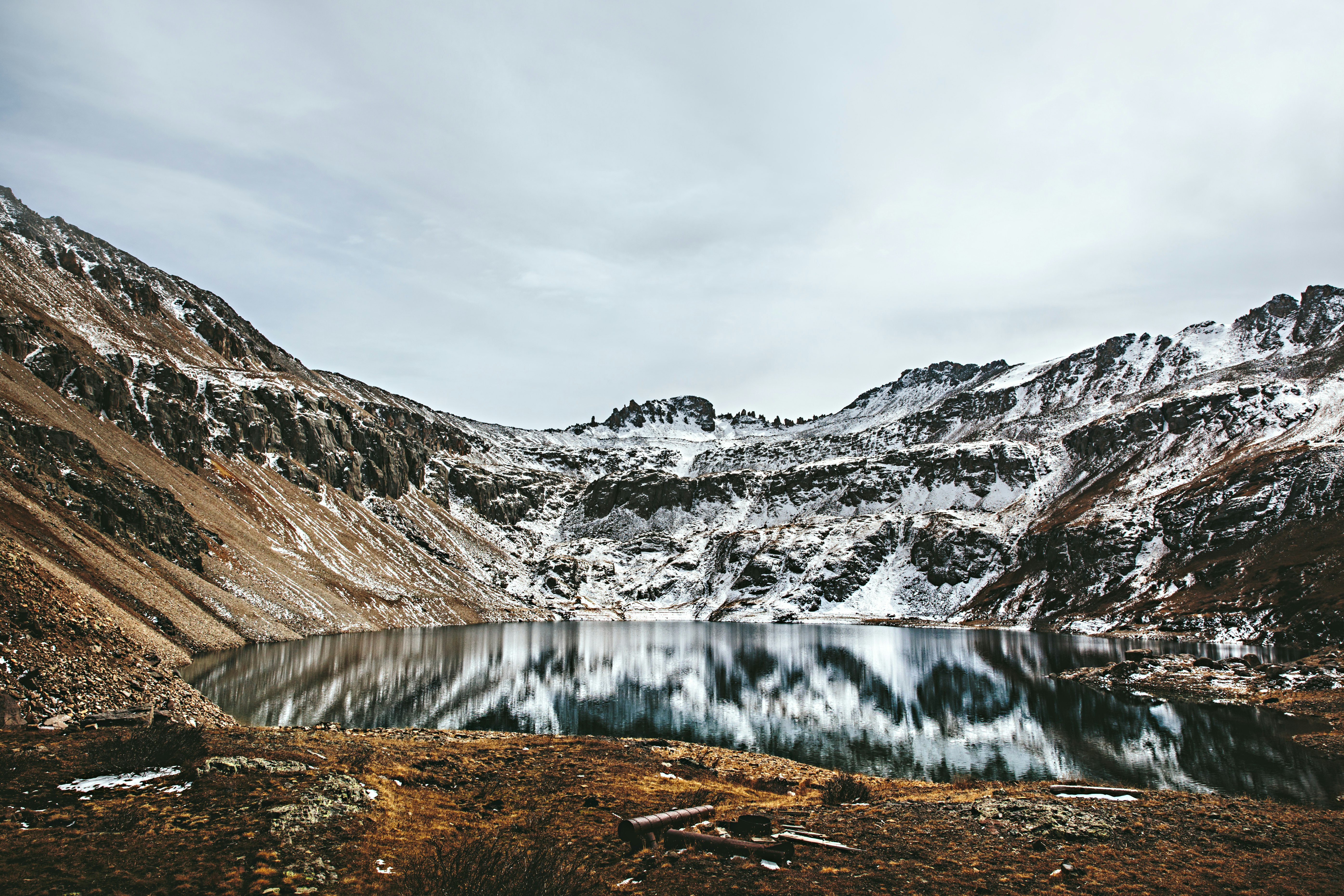 brown rocky mountain beside body of water